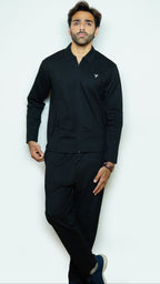 Man wearing a black outfit with a logo on a white background