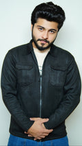 Man wearing a black jacket and blue pants against a white background