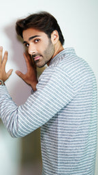 Man wearing a striped shirt against a plain background