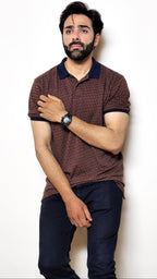 Man wearing a patterned polo shirt and jeans on a white background