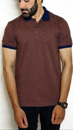 A man wearing a navy and light brown geometric patterned polo shirt with a collar.